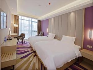 a hotel room with a large bed and a desk at Lavande Hotel Xi'an Bell Tower in Xi'an