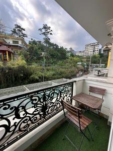 a balcony with a bench and a table on it at Tommy hotel khe sanh dalat in Da Lat
