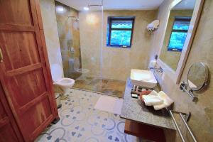 a bathroom with a toilet and a sink and a shower at Arbor Road Estate in Pāmalparti +20 photos