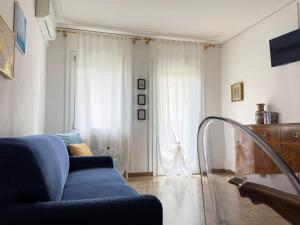 a living room with a blue couch and a window at ApartmentsPadova in Padova