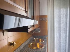 a bathroom with two sinks in a kitchen at ApartmentsPadova in Padova +37 photos