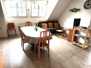 a living room with a table and a couch at A l'Orée du Bois ''Les Hêtres'' in Guewenheim