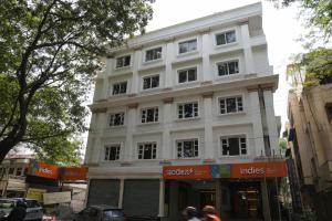a large white building on a city street at The Indies 365 Hotel in Bangalore