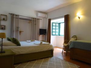 a hotel room with a bed and a window at New Village in Vila Nova da Baronia +43 photos