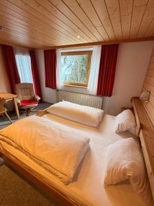 a bedroom with two beds in a room at Haus Brunelle in Damuls +7 photos