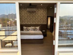 a bedroom with a bed on top of a balcony at STARLIT Hotel, Ajmer in Madār