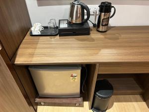 a counter with a coffee maker and a blender on it at STARLIT Hotel, Ajmer in Madār