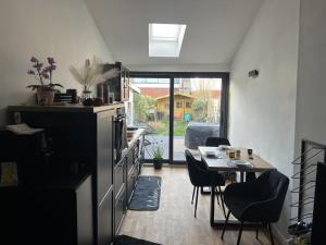 a kitchen and dining room with a table and chairs at NEU! Dat Lütt Hüs in Tönning