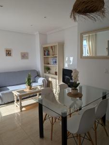 a living room with a table and a couch at Urbanización Torremar Natura in Vera