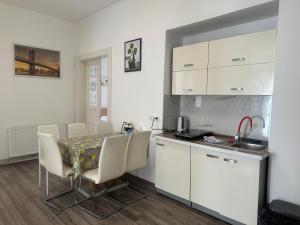 a kitchen with a table and chairs in a room at KK Apartments in Prague