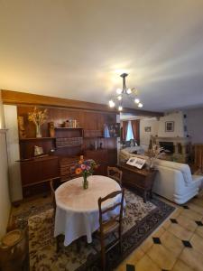 a living room with a table and a couch at L'épi de blé in Saint-Astier