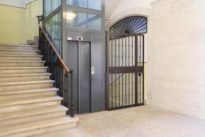 a black door in a building with stairs at Tiare' in Trani