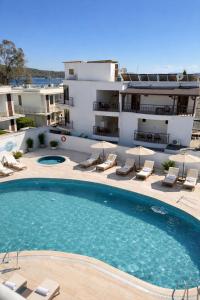 a large swimming pool in front of a building at Salinas Hotel in Gümbet