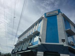 a building with a sign on the side of it at Casa-Miranda Homestay in Daet