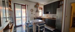 a kitchen with a table and some chairs in it at Ettorina in Cogoleto