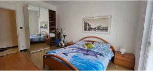 a bedroom with a bed and a mirror at Ettorina in Cogoleto