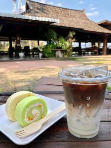 a cup of tea and a plate with a pastry and a drink at Chomphu Phukha Resort-Mountain View Nan in Pua