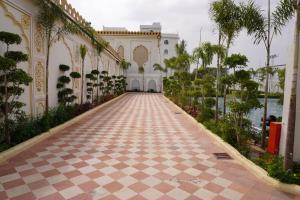 a courtyard of a building with a tiled walkway at Neendar Heritage Resort in Jaipur