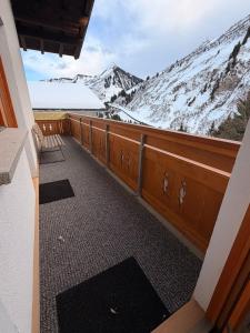 a balcony with a view of a snow covered mountain at Haus Brunelle in Damuls