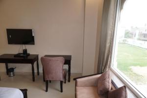 a hotel room with a desk and a window at Neendar Heritage Resort in Jaipur