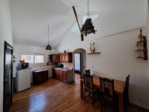 a kitchen and dining room with a dining table and a kitchen and a dining room at L'Isba in Saint-Appolinaire +13 photos