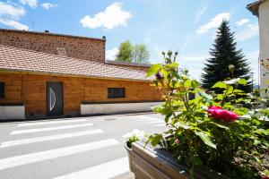 a parking lot with a building with a garage at L'Isba in Saint-Appolinaire