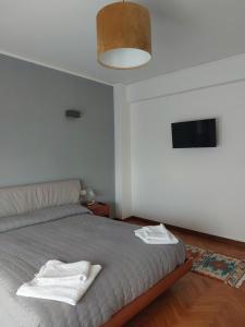 a bedroom with a bed with two towels on it at Splendid Lido in Venice-Lido +6 photos