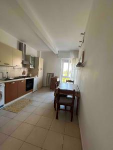 a kitchen with a table and a dining room at Splendid Lido in Venice-Lido