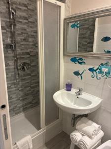 a bathroom with a sink and a shower at Affittacamere La Risacca in La Spezia
