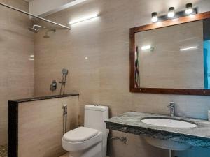 a bathroom with a toilet and a sink and a mirror at The Three Oaks Boutique Hotel in Mussoorie +52 photos