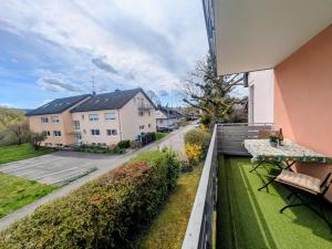 a balcony of a house with a table and a street at Fewo Marek in Gaienhofen