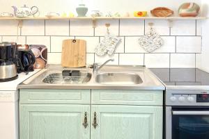 a kitchen with a sink and a counter top at Zach Waldglück in Groß Klessow +8 photos