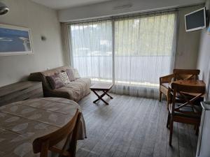 a living room with a couch and a table at Arcachon Plage Pereire in Arcachon