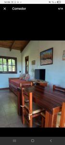 a bedroom with a table and a bed and a desk at cabaña La Retama in Villa Yacanto