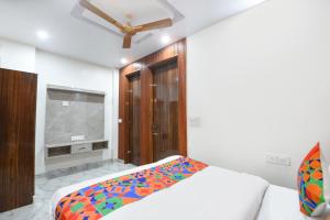 a bedroom with a bed and a flat screen tv at Via The Arrow in New Delhi