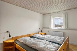 a bedroom with two beds and a window at Sorø Camping & Cottages in Sorø
