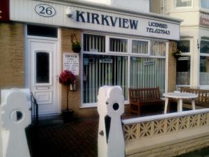 a coffee shop with a table in front of it at The Kirkview in Blackpool