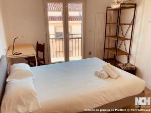 a bedroom with a bed with two towels on it at Fuentes 8 in Soria