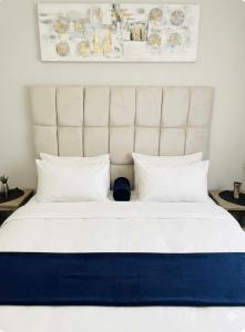 a large white bed with a large white headboard at DeltaGateway selfcatering in Maun Airport