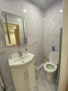 a white bathroom with a toilet and a sink at Standish Haven Ensuite Room in Standish +22 photos