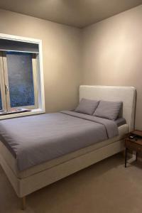 a bed in a bedroom with a window at Bergen Apartment with a view in Bergen
