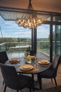 a dining room table with chairs and a chandelier at Bergen Apartment with a view in Bergen