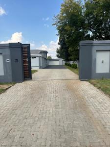 a brick driveway with two gates in a house at Eagle Empire in Vereeniging