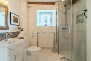 a bathroom with a shower and a toilet and a sink at 4 Crown Cottages in Moreton in Marsh +35 photos