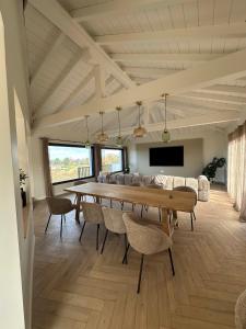 a large dining room with a table and chairs at Villa ALDAKETA in Urrugne