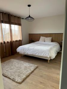 a bedroom with a white bed and a rug at Villa ALDAKETA in Urrugne +27 photos