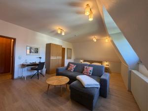 a living room with a couch and a table at Hotel Liszt in Weimar