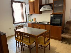 a kitchen with a table and chairs in a kitchen at Incanto dei sibillini- Piazza Perfetti 16 in Sarnano