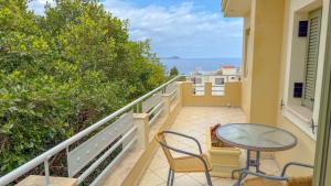 a balcony with a table and chairs and the ocean at Klelia Hotel in Monemvasia
