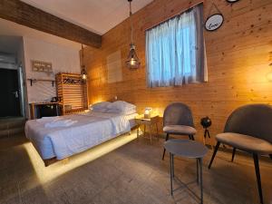 a bedroom with a bed and two chairs and a window at Penélope Hotel in Ialysos +54 photos